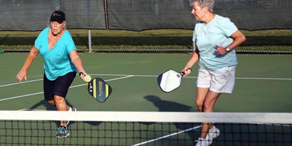 two ladies playing pickleball