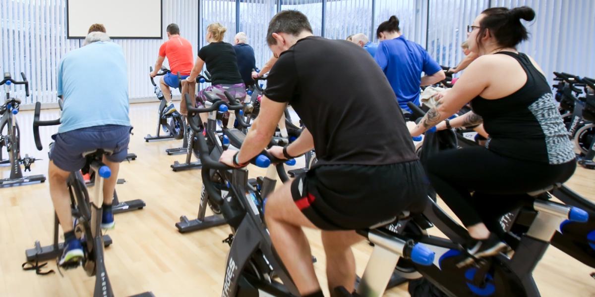 Photo of members in cycle class