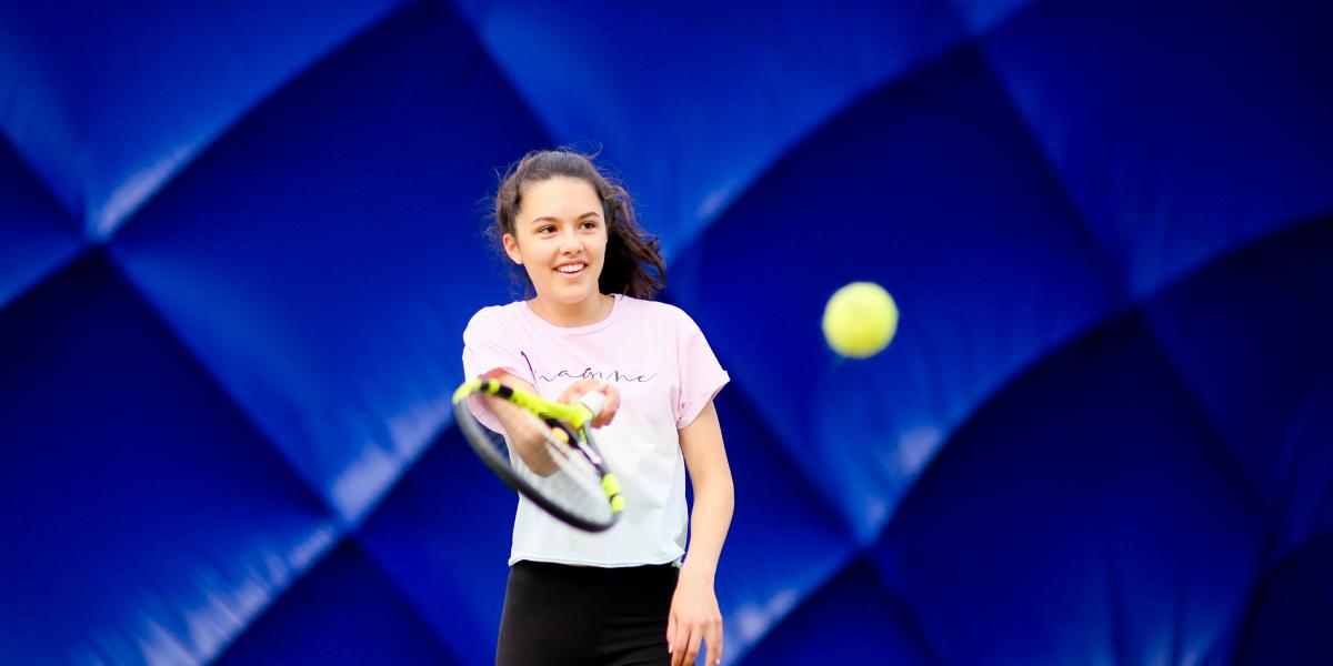 Girl playing Tennis in the Dome at Comber Leisure Centre