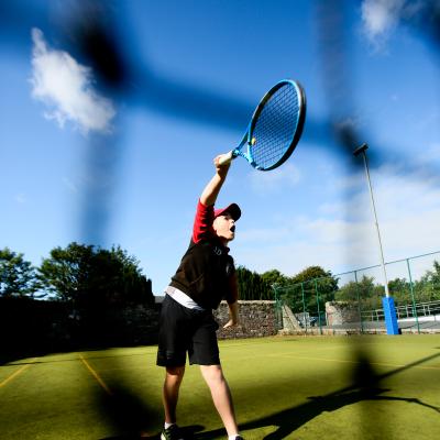 Boy playing Tennis outdoors at Comber Leisure Centre